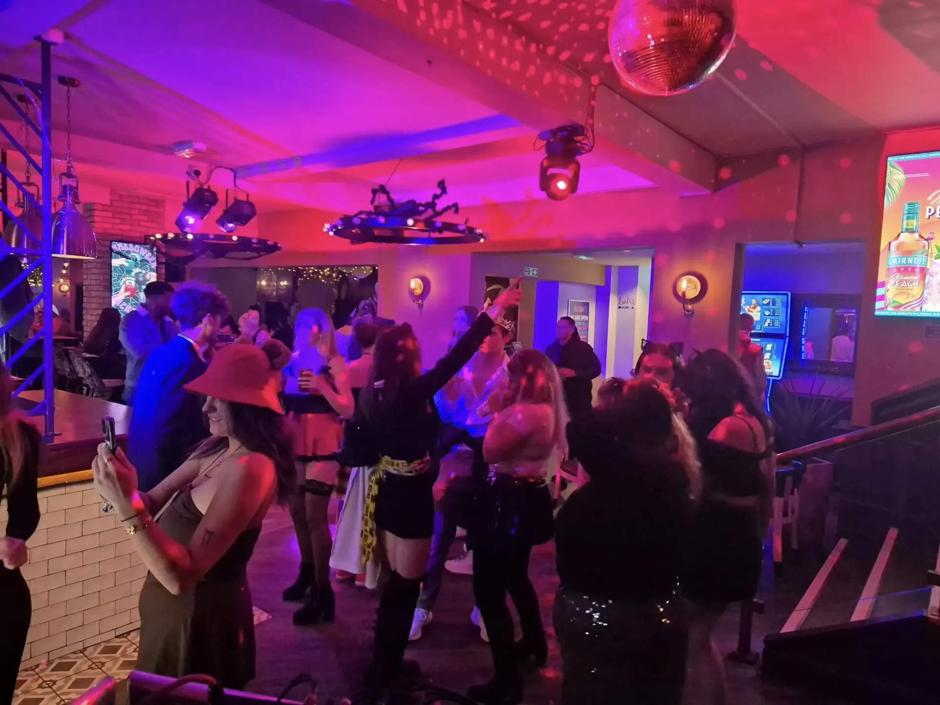 Guests dancing at a Halloween pub party