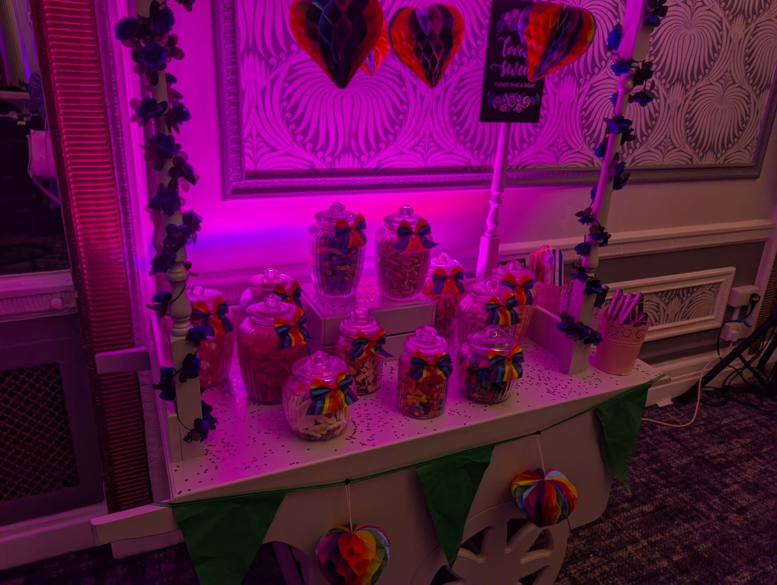 Rainbow themed sweet cart at a Sussex party