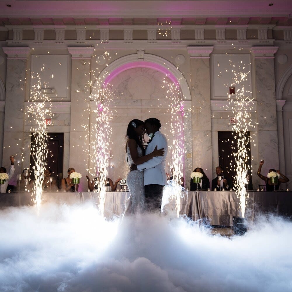 Couple's first dance on low fog with cold spark fountains